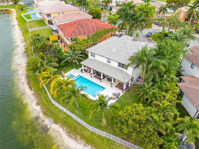 birds eye view of property with a water view and a residential view