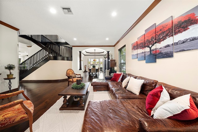living room with stairs, recessed lighting, wood finished floors, visible vents, and ornamental molding