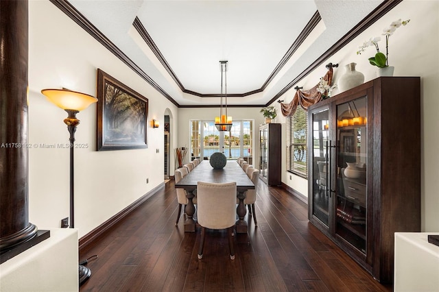 dining area with dark wood-style flooring, baseboards, and ornamental molding