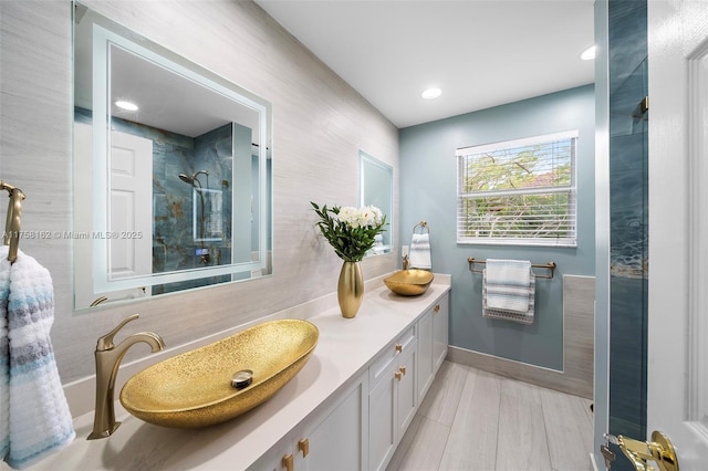 bathroom featuring tasteful backsplash, vanity, and a tile shower