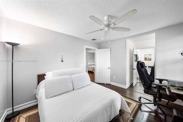 bedroom featuring visible vents, dark wood-type flooring, baseboards, ceiling fan, and a textured ceiling