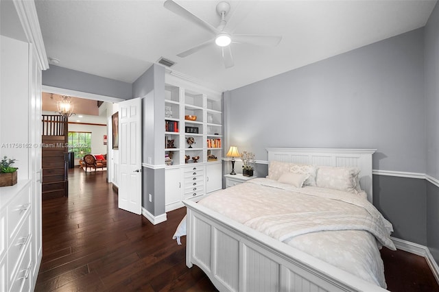bedroom featuring baseboards, visible vents, ceiling fan with notable chandelier, and dark wood-type flooring