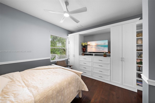 bedroom featuring a ceiling fan, visible vents, and dark wood-style floors