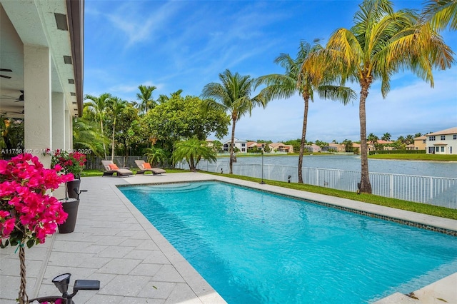 view of pool with a fenced in pool, a water view, a fenced backyard, and a patio area