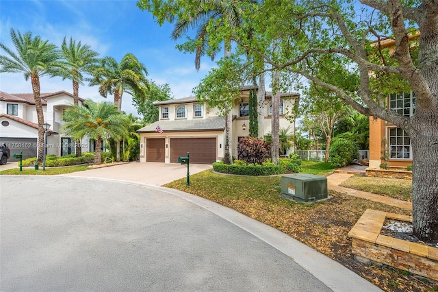 view of front of house featuring stucco siding, concrete driveway, and a garage