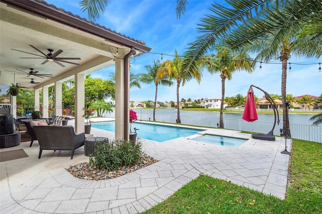 view of pool featuring fence, a fenced in pool, an in ground hot tub, ceiling fan, and a patio area