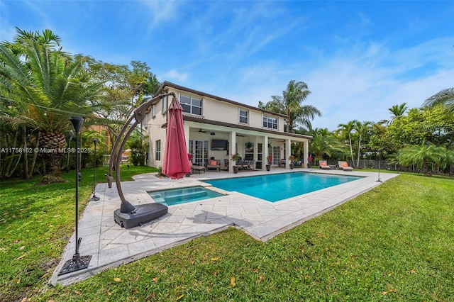 pool featuring fence, a ceiling fan, a patio, and a yard