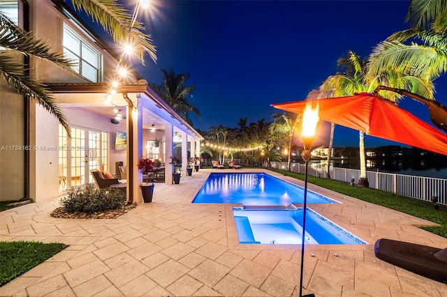 view of pool with a fenced in pool, french doors, a fenced backyard, a patio area, and an in ground hot tub