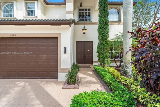 view of front facade featuring decorative driveway and stucco siding