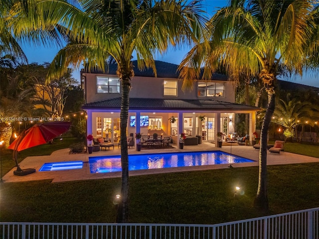 exterior space with a fenced in pool, a patio, a lawn, and outdoor lounge area