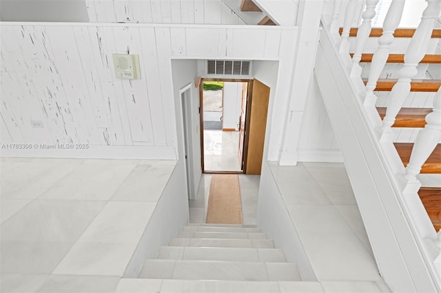 stairs featuring tile patterned flooring and visible vents