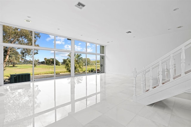 stairs with recessed lighting, visible vents, and expansive windows