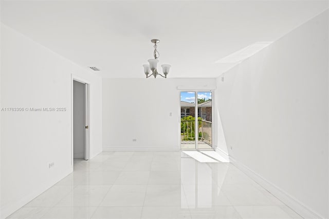 spare room featuring light tile patterned flooring, visible vents, baseboards, and a chandelier