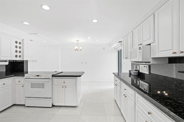 kitchen with backsplash, white cabinetry, white appliances, an inviting chandelier, and a peninsula