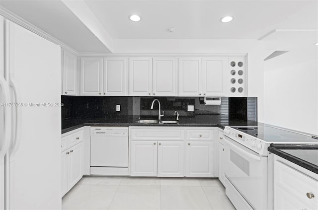 kitchen featuring a sink, decorative backsplash, white appliances, and white cabinetry