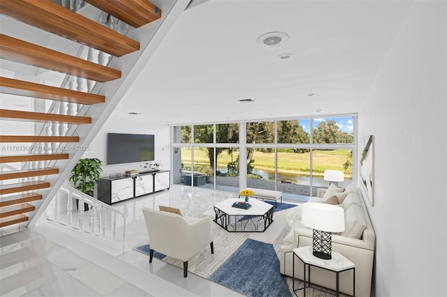 living room featuring stairs, recessed lighting, and expansive windows