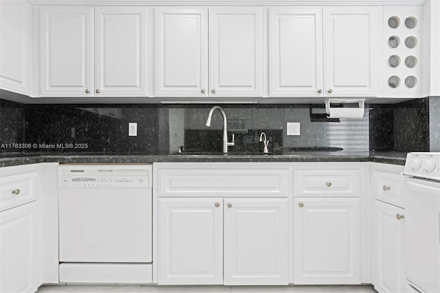 kitchen featuring dark stone counters, decorative backsplash, stove, white cabinets, and dishwasher