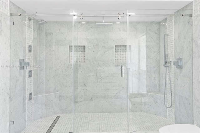 full bath with a marble finish shower