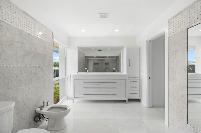 full bathroom featuring vanity, a bidet, visible vents, a stall shower, and toilet