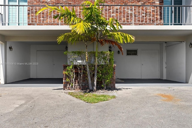 exterior space with brick siding and stucco siding