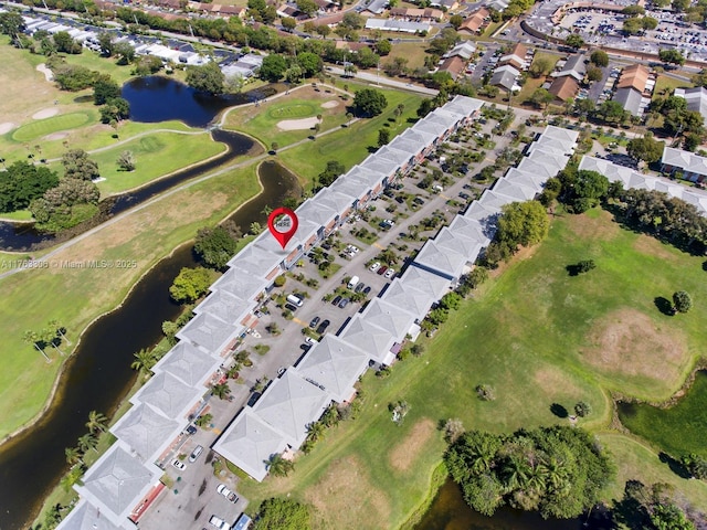 birds eye view of property featuring a residential view, a water view, and view of golf course