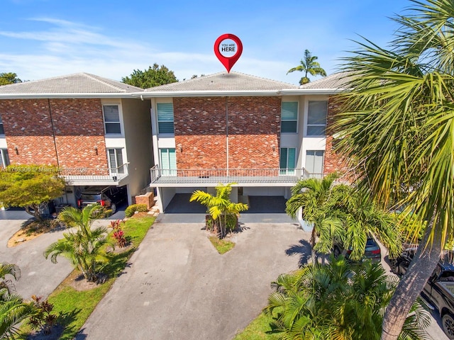 view of property with a carport and driveway