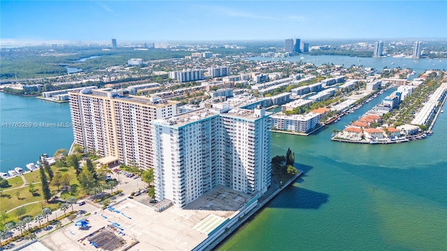 drone / aerial view featuring a city view and a water view