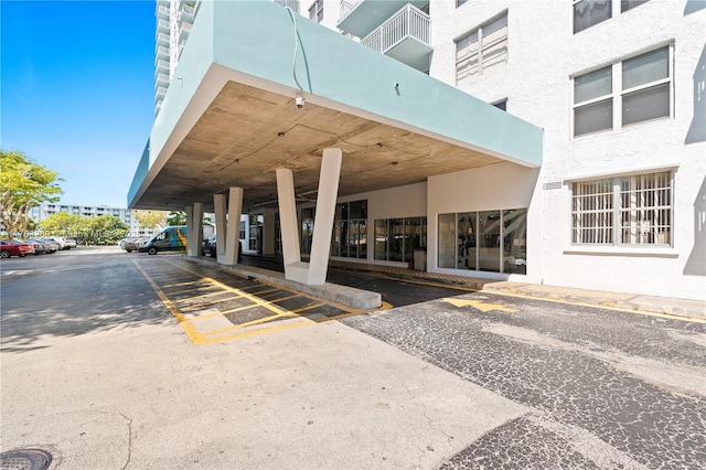 view of building exterior featuring covered parking