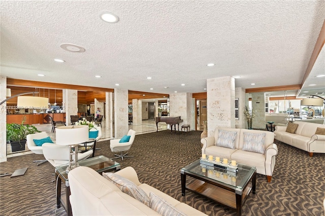 living room with carpet flooring, recessed lighting, a textured ceiling, and plenty of natural light