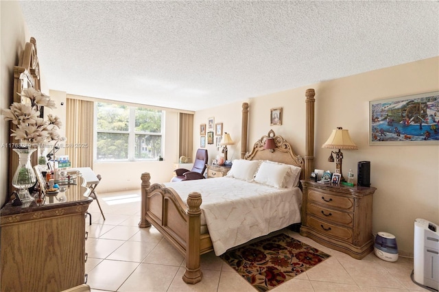 bedroom featuring light tile patterned flooring and a textured ceiling