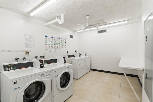 common laundry area with washer and dryer, visible vents, ceiling fan, and light tile patterned floors