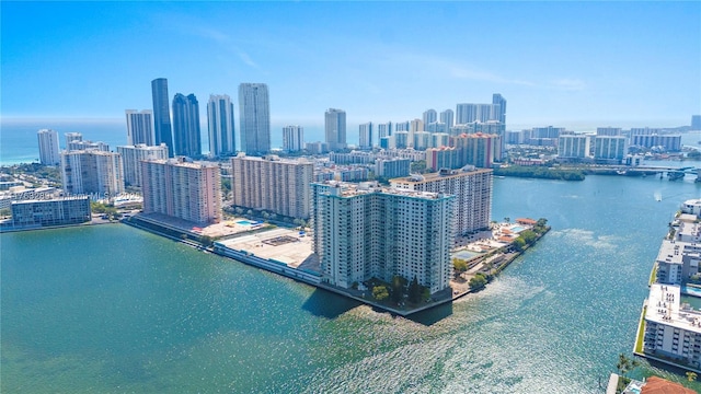 birds eye view of property featuring a view of city and a water view