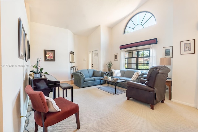 living room featuring baseboards, carpet floors, and high vaulted ceiling