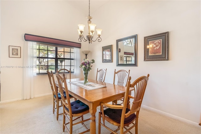 dining room featuring baseboards, an inviting chandelier, and carpet flooring