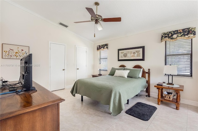 bedroom featuring visible vents, baseboards, light tile patterned floors, lofted ceiling, and ceiling fan