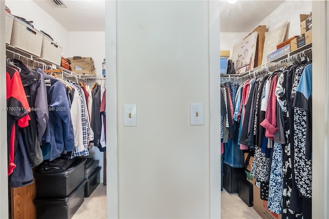 walk in closet with tile patterned floors