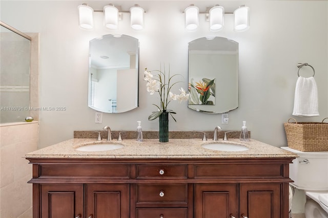 full bath featuring double vanity, toilet, and a sink