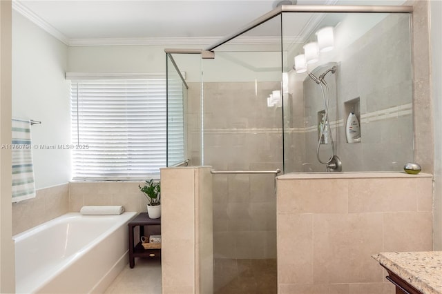 bathroom featuring a stall shower, a garden tub, and ornamental molding