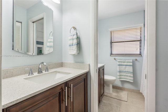 full bathroom with vanity, tile patterned floors, and toilet