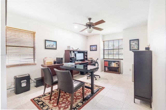 office space with light tile patterned floors and a ceiling fan