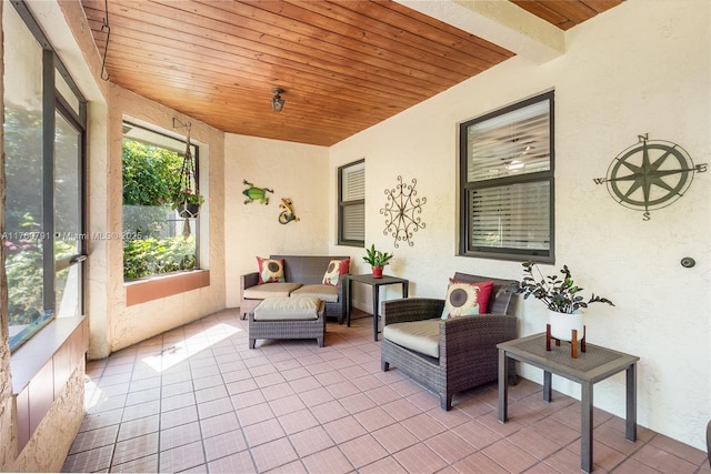 sunroom / solarium featuring wooden ceiling and beamed ceiling