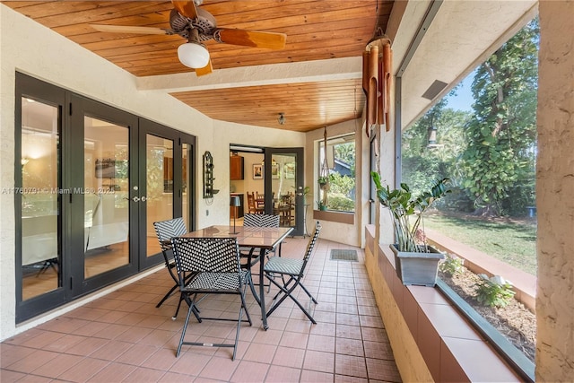 sunroom / solarium with wooden ceiling, french doors, and ceiling fan