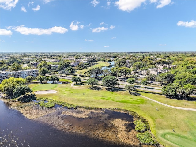 drone / aerial view with view of golf course and a water view