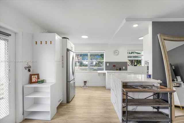 1 Keswick A 1, Deerfield Beach, FL 33442 - kitchen with freestanding refrigerator, white cabinets, light wood-type flooring, recessed lighting, and tasteful backsplash