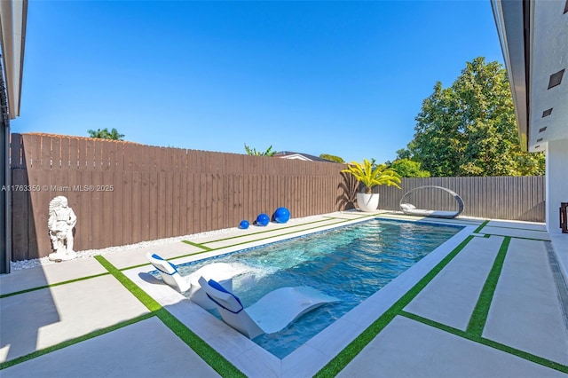 view of pool featuring a patio, a fenced in pool, and a fenced backyard