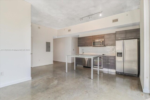 151 SE 1st St Unit 1011, Miami, FL 33131 - kitchen featuring stainless steel appliances, electric panel, finished concrete floors, light countertops, and backsplash