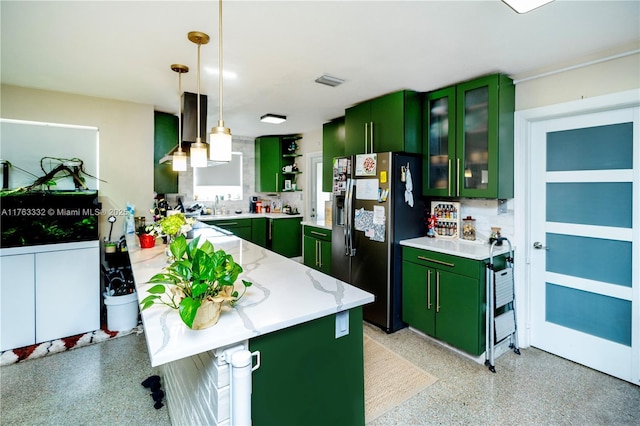 kitchen with visible vents, pendant lighting, light speckled floor, stainless steel fridge with ice dispenser, and green cabinetry