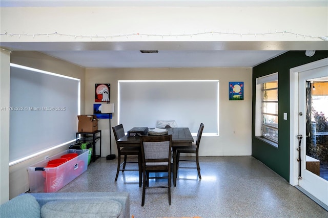 dining space featuring speckled floor