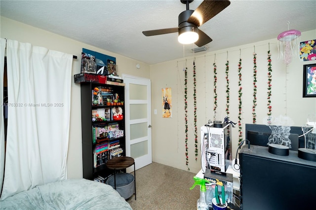 bedroom with a textured ceiling and ceiling fan