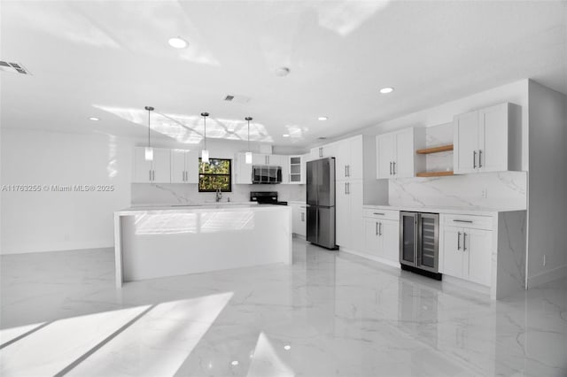 kitchen featuring visible vents, beverage cooler, open shelves, stainless steel microwave, and freestanding refrigerator